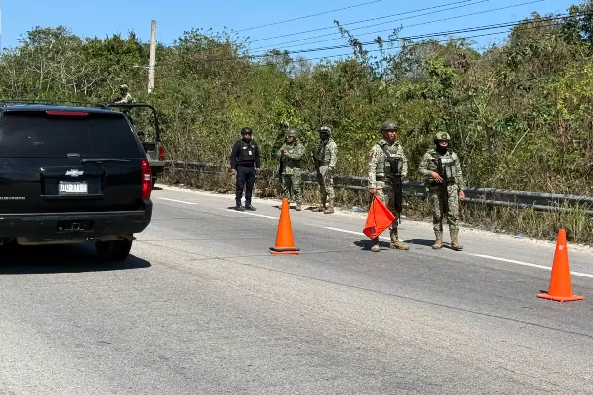 A police vehicle damaged by gunfire on a dirt road in Puerto Aventuras, Quintana Roo