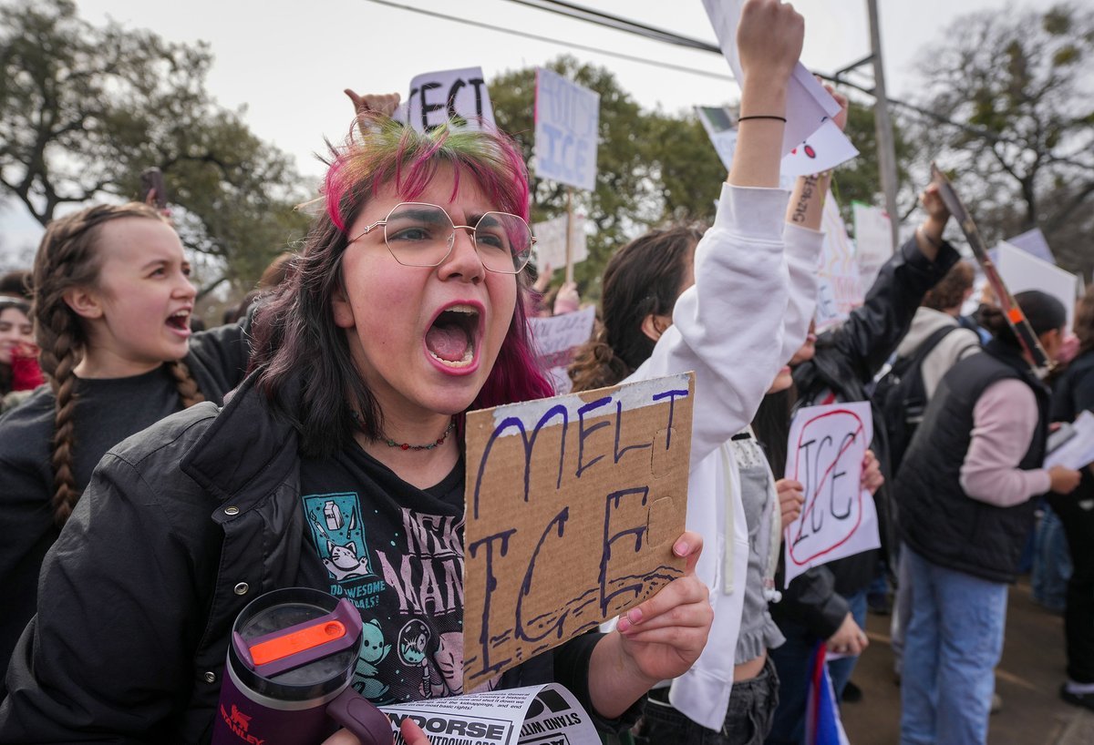 Protesters gather in Austin, Texas, holding signs against ICE actions during a national demonstration