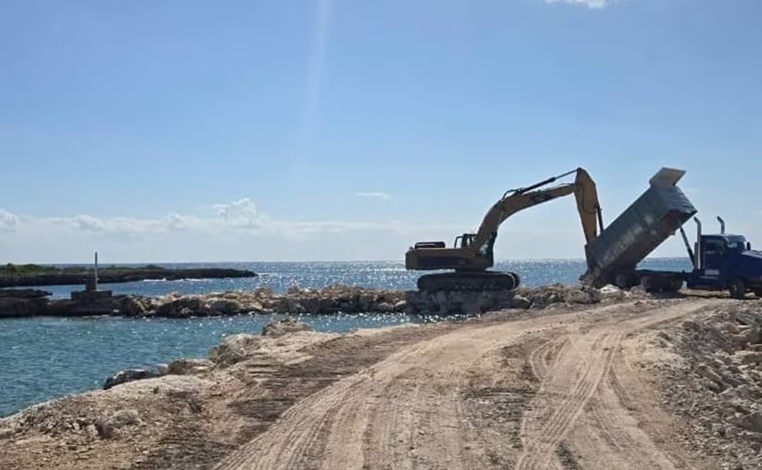 Heavy machinery blocking a coastal inlet with rocks in Puerto Aventuras, Quintana Roo