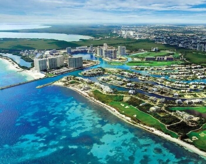 A security guard in a vehicle questions a man on a beach in Cancún, Mexico