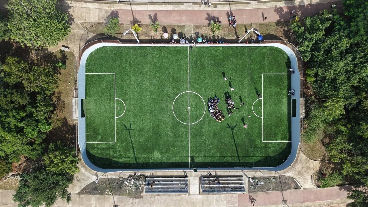 Aerial view of a soccer field in Quintana Roo, Mexico, with construction equipment visible