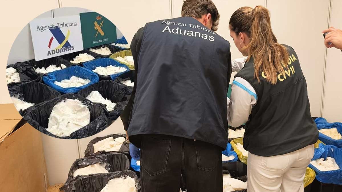 Spanish police officers inspecting seized containers of methamphetamine disguised as coconut oil