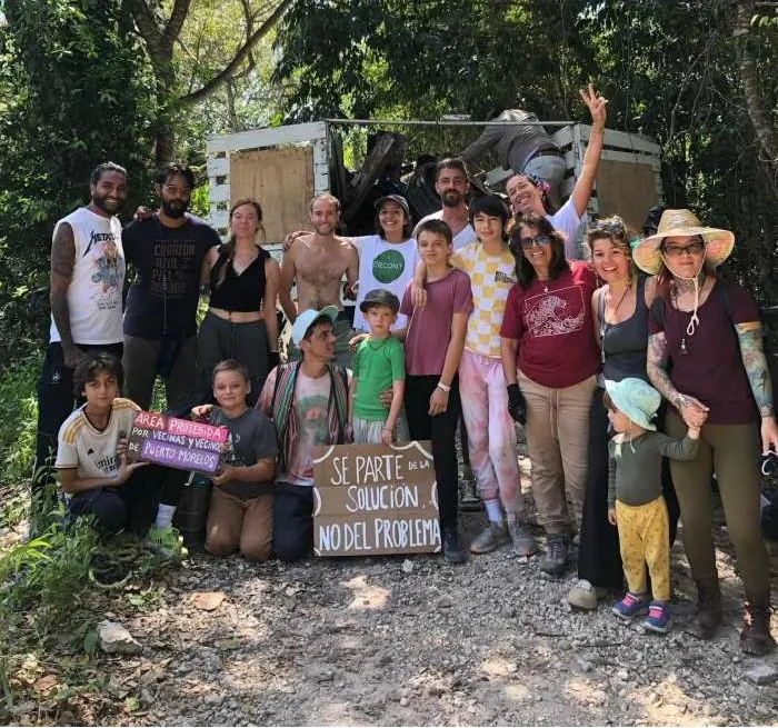 Members of the Toma Las Aguas collective holding signs at a demonstration in Puerto Morelos
