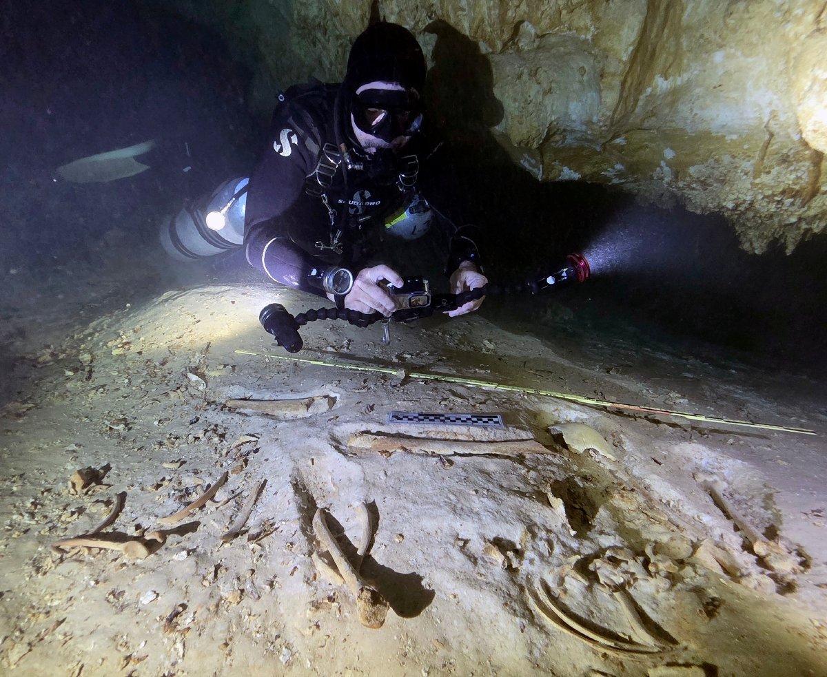 Underwater archaeologist Octavio del Río explores a flooded cave system near Tulum, Mexico