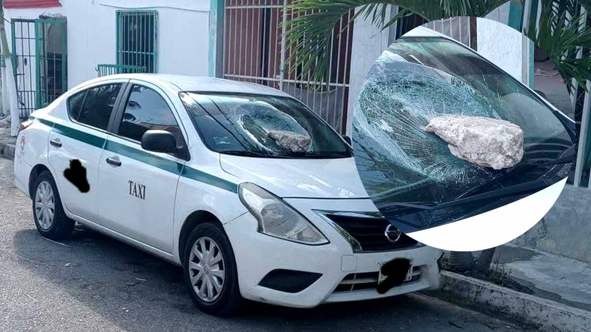 A street scene in Cancún showing parked cars with broken windows after a vandalism spree