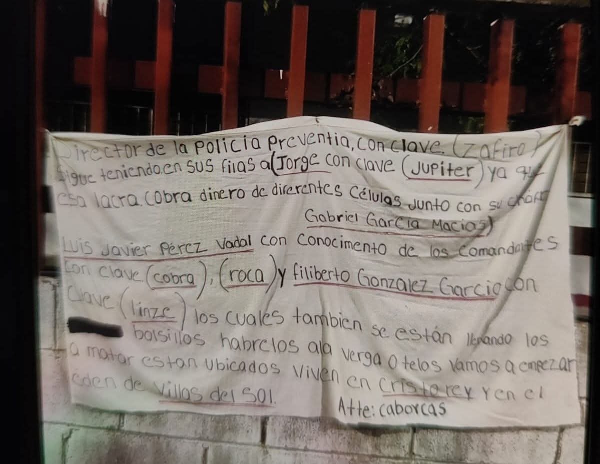 A handwritten notice outlining local crime activities and individuals involved, taped to a wall or fence.$# CAPTION