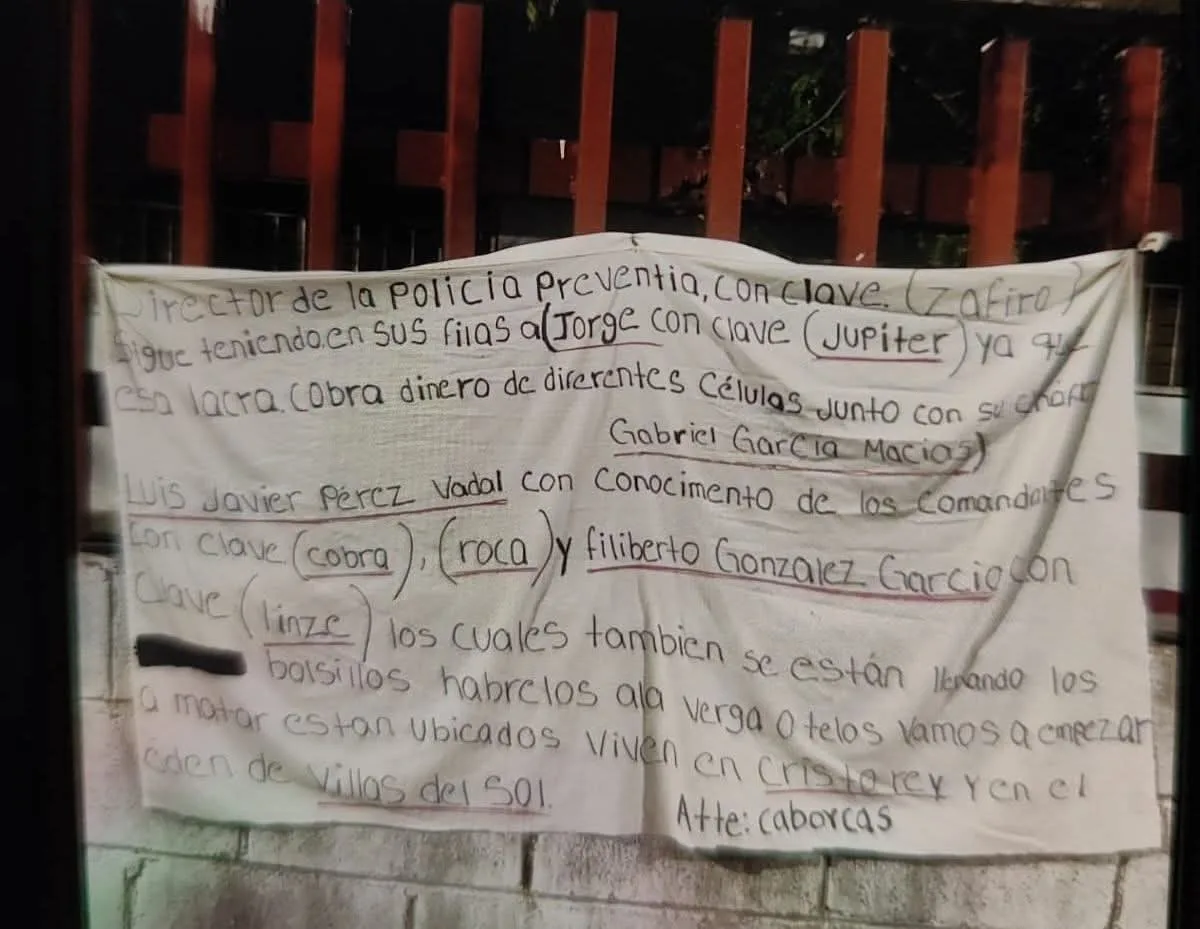 A handwritten notice outlining local crime activities and individuals involved, taped to a wall or fence.$# CAPTION