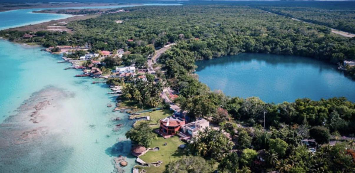 Aerial view of Bacalar, Quintana Roo, showing the Laguna de los Siete Colores and surrounding development