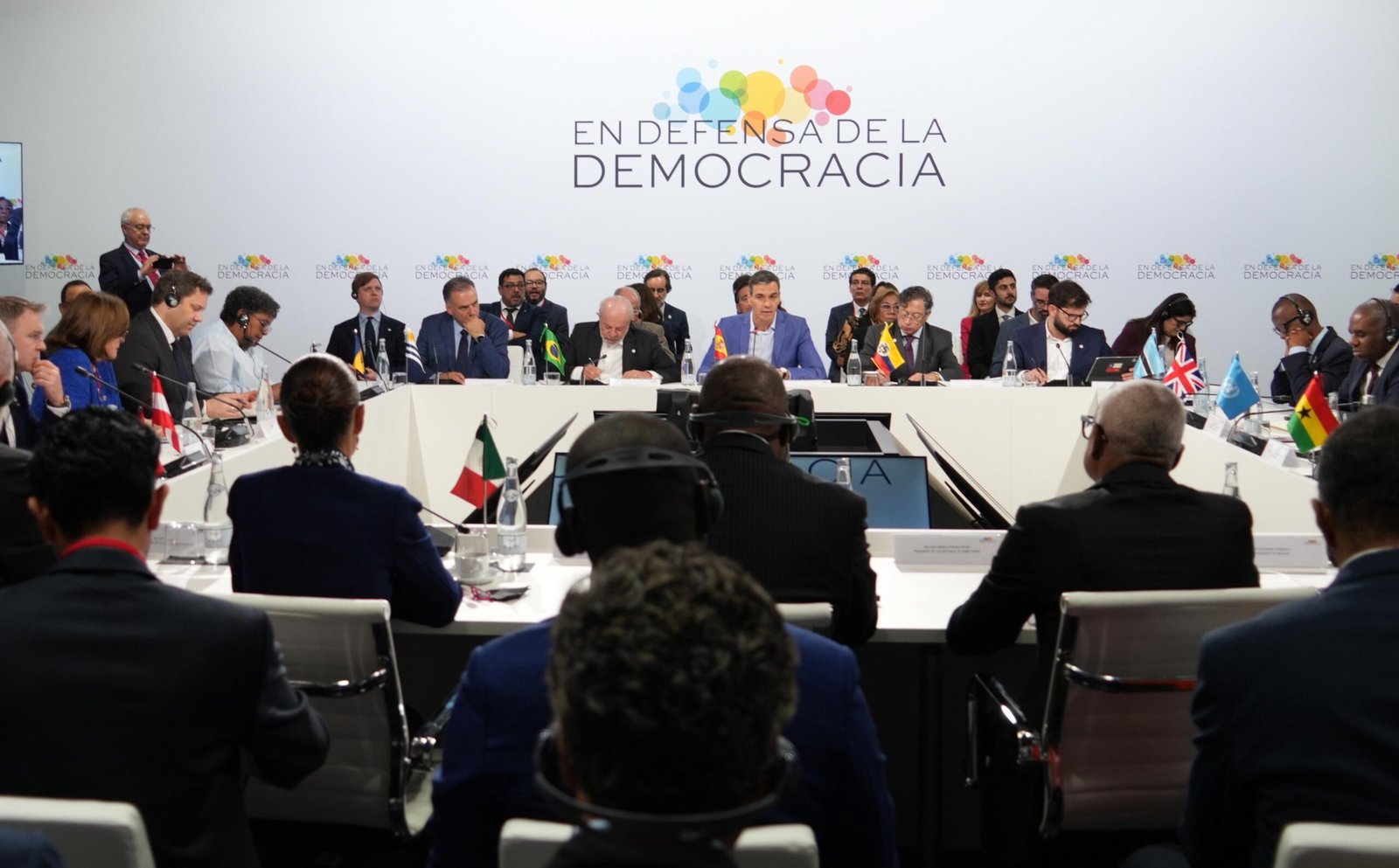 Flags of Brazil, Spain and Mexico with a map of Cuba in the background