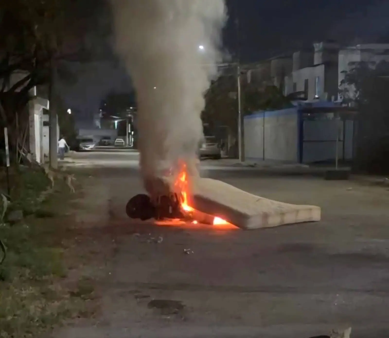 A burnt motorcycle on a street in Cancun after a mob set it on fire during a lynching attempt against a suspected child abuser.