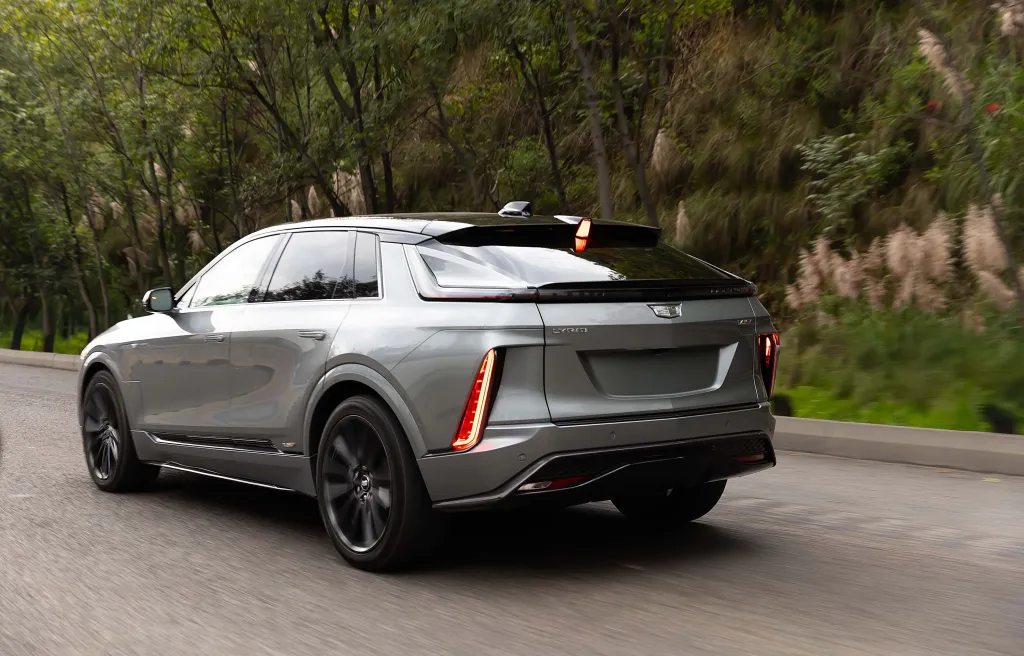 The Cadillac LYRIQ V 2026, a sleek black electric SUV, parked on a road.