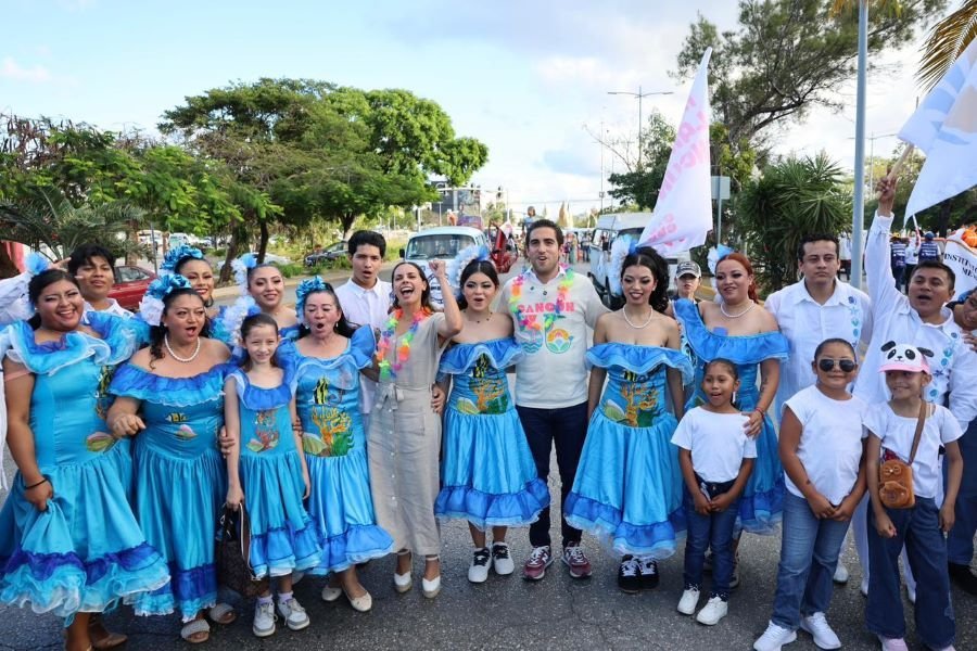 A colorful parade in Cancún featuring floats, marching bands, and participants in traditional and retro attire celebrating the city's 56th anniversary.