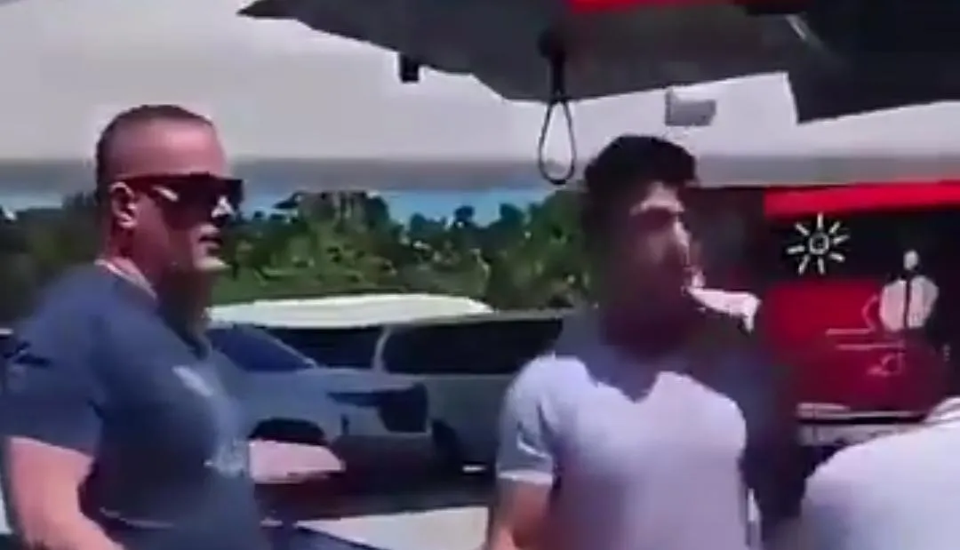 Video still showing a confrontation between a tourist and a service worker at Cancun International Airport