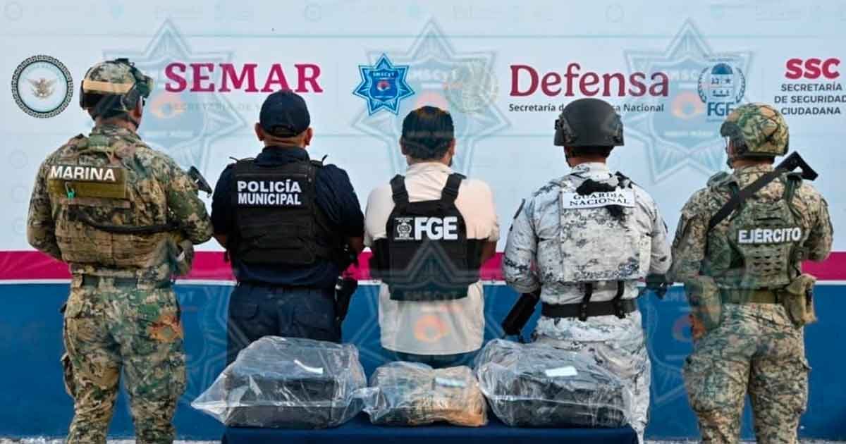 Three plastic-wrapped packages containing suspected marijuana seized on a Cancún beach