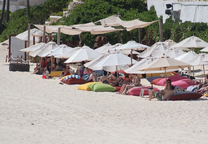 A view of sun loungers and umbrellas on a beach in Cancún, Mexico