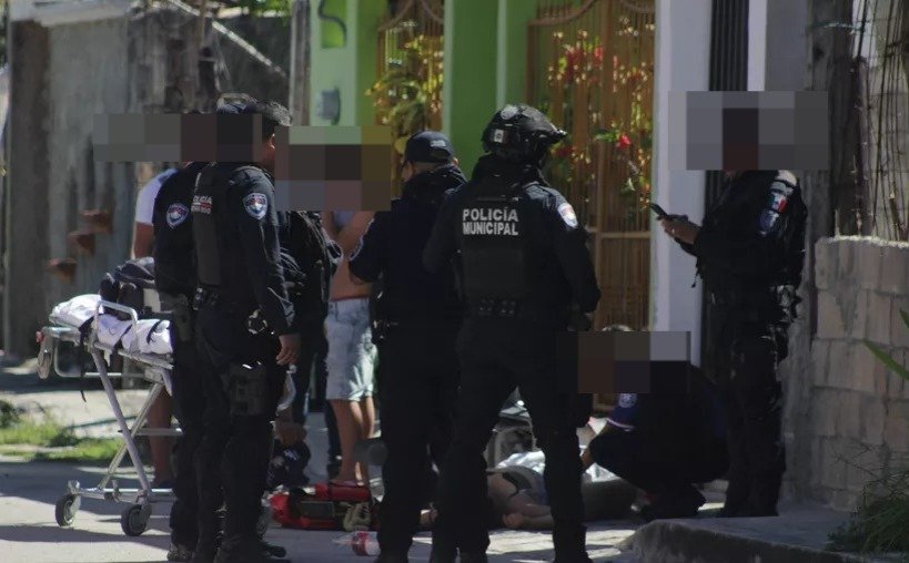 A busy street in downtown Cancun with shops and pedestrians