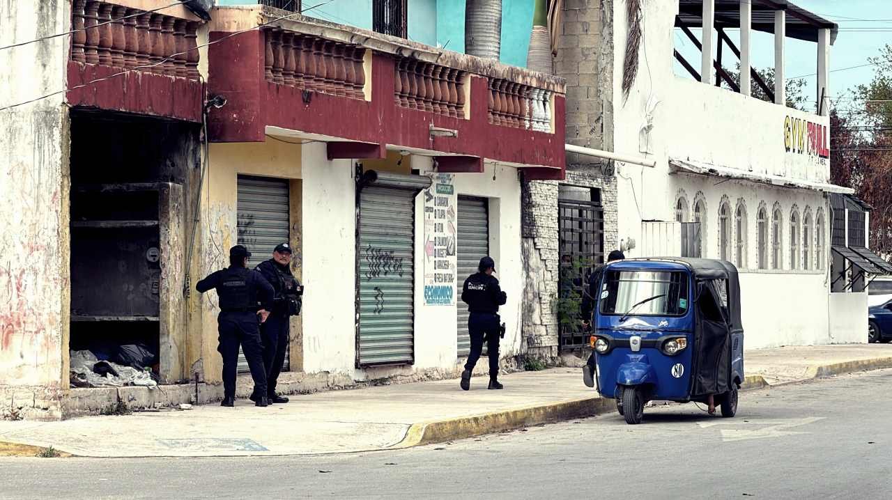 Police and emergency responders at the scene where a mototaxi driver was shot and killed in Cancún