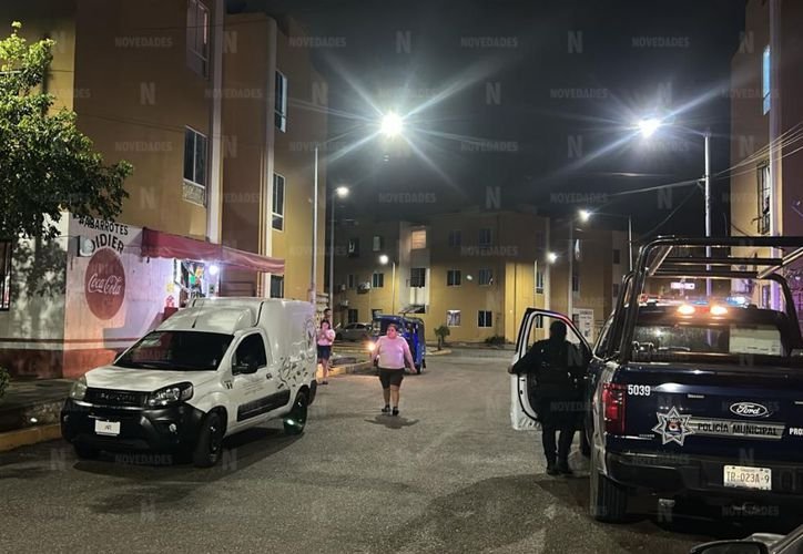 Police and firefighters at a residential scene in Cancun where a body was discovered