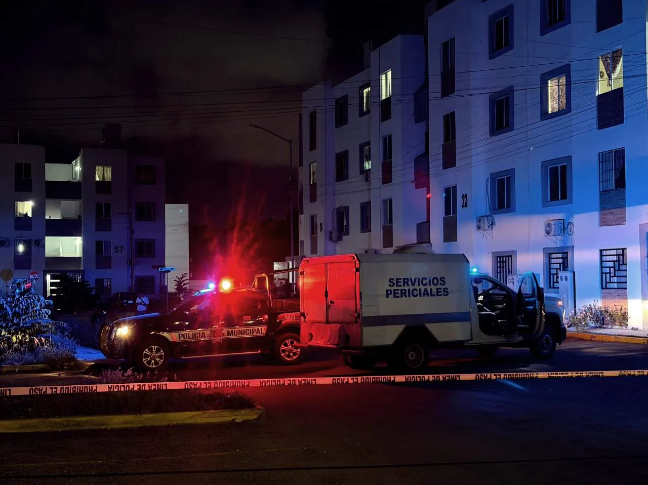 Police and forensic investigators at the scene of a shooting in Cancun's Paseo Kusamil neighborhood