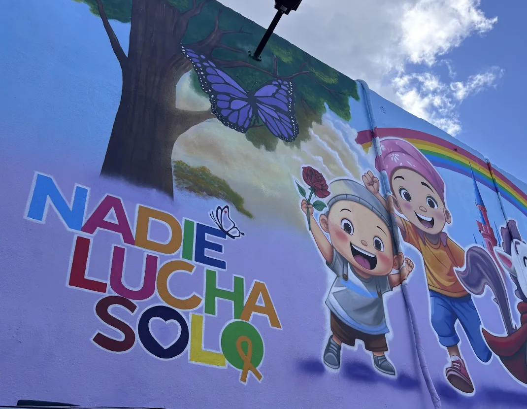 A child cancer patient lying in a hospital bed surrounded by medical equipment in Quintana Roo