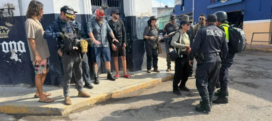 Police officers speaking with film crew members on a street in Tizimin, Yucatan