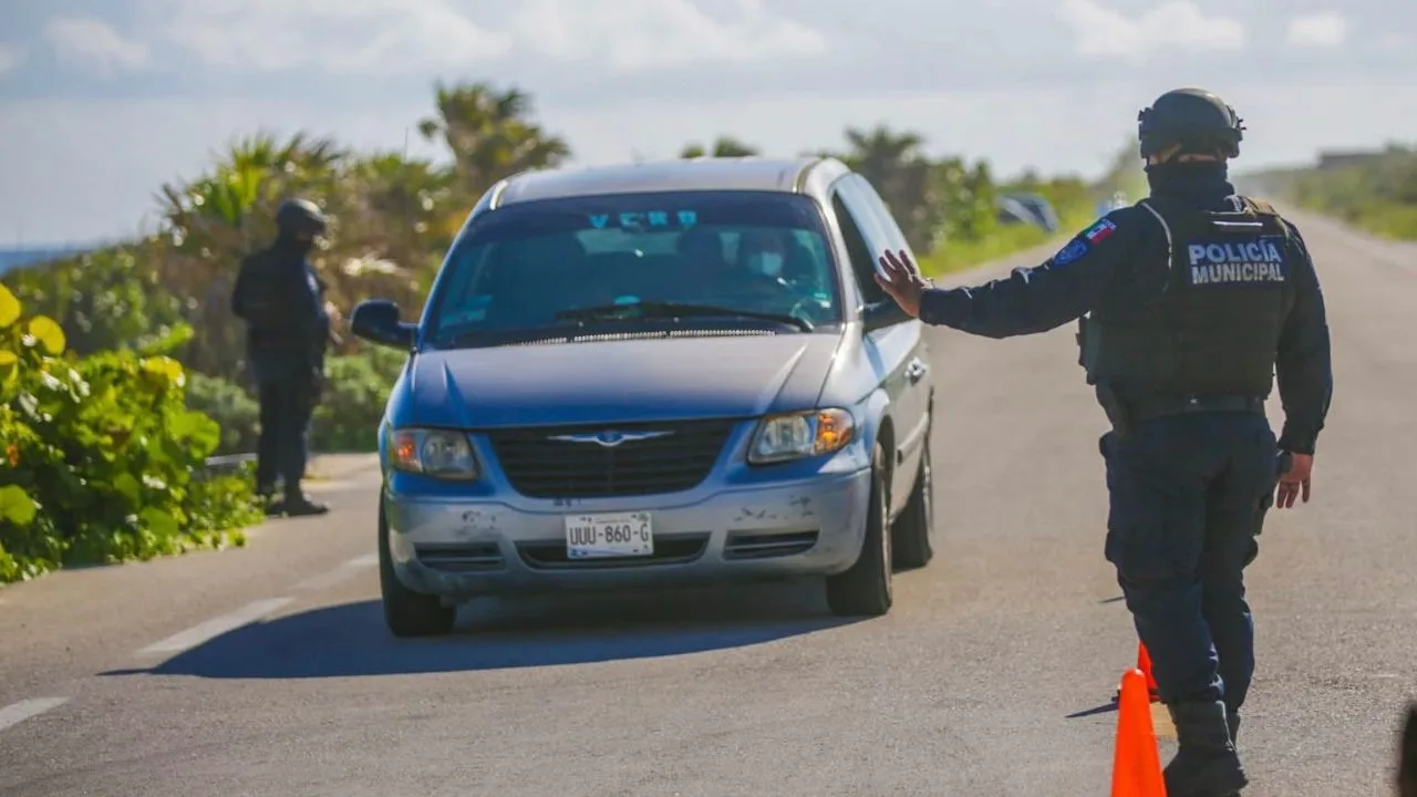 Security personnel conducting patrols on a Cozumel beach during the holiday season