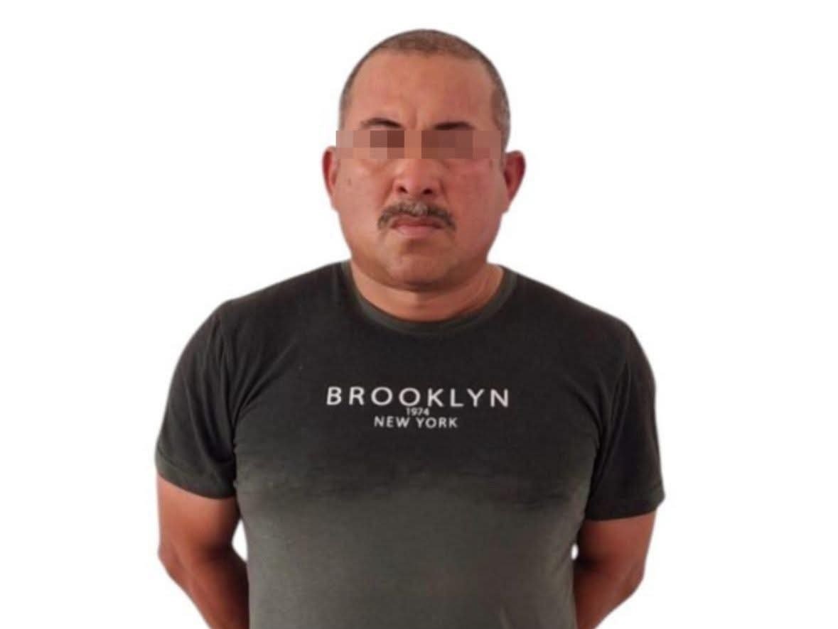 Police officers stand next to a vehicle and evidence seized during a drug arrest in Cozumel