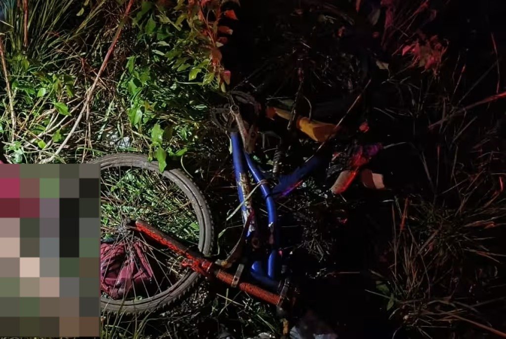 Police tape and emergency vehicles on a highway at night