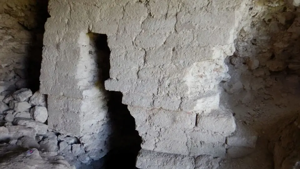Aerial view of the El Jefeciño archaeological site showing large Maya structures in a forested area