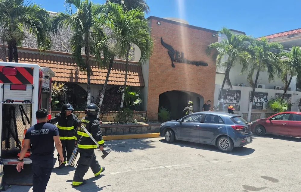 Firefighters work at the scene of a restaurant fire in Playa del Carmen