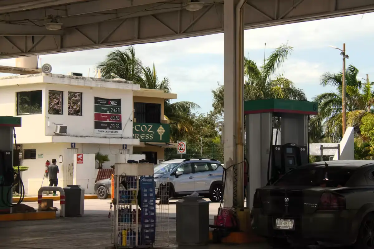 A gas station price sign in Quintana Roo showing fuel prices above the national average