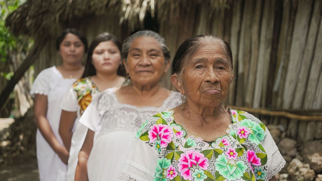 A grandmother from Quintana Roo sharing traditional Maya knowledge with younger generations