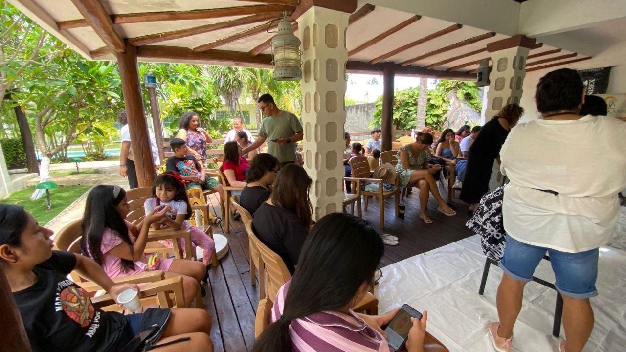 Volunteers and donors at a hair collection event in Playa del Carmen, with hair being prepared for use in oil spill barriers