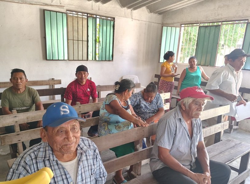 A gathering of Maya community members discussing cultural rights and compensation from Grupo Xcaret