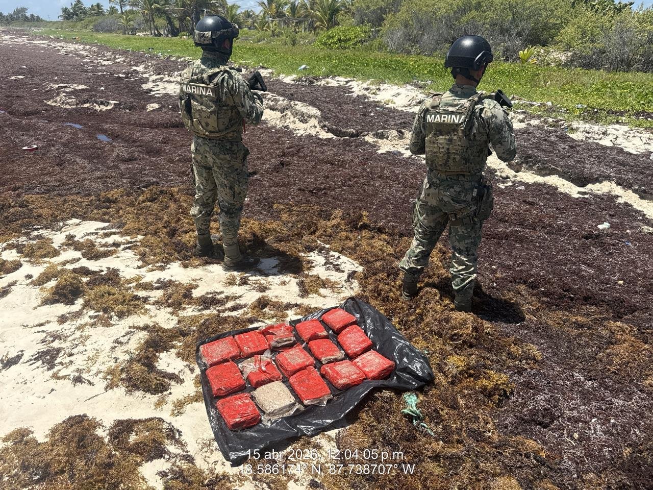 Mexican Navy personnel in uniform inspecting packages on a beach near Mahahual, Quintana Roo