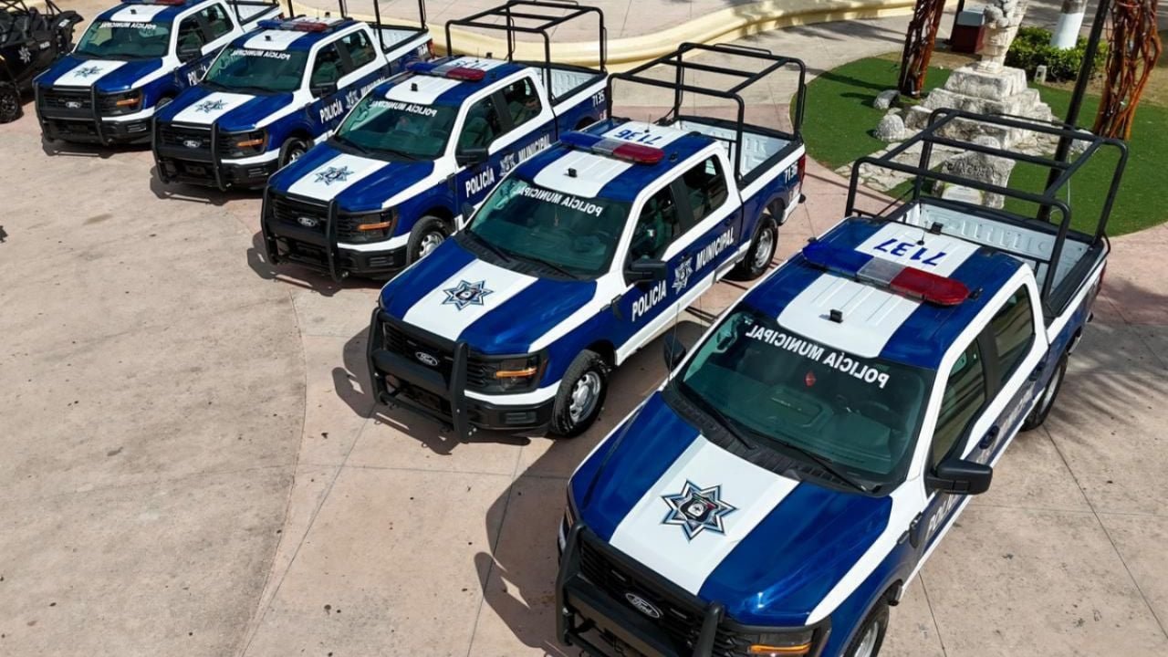 Governor Mara Lezama stands next to new police vehicles during a delivery ceremony in Cozumel