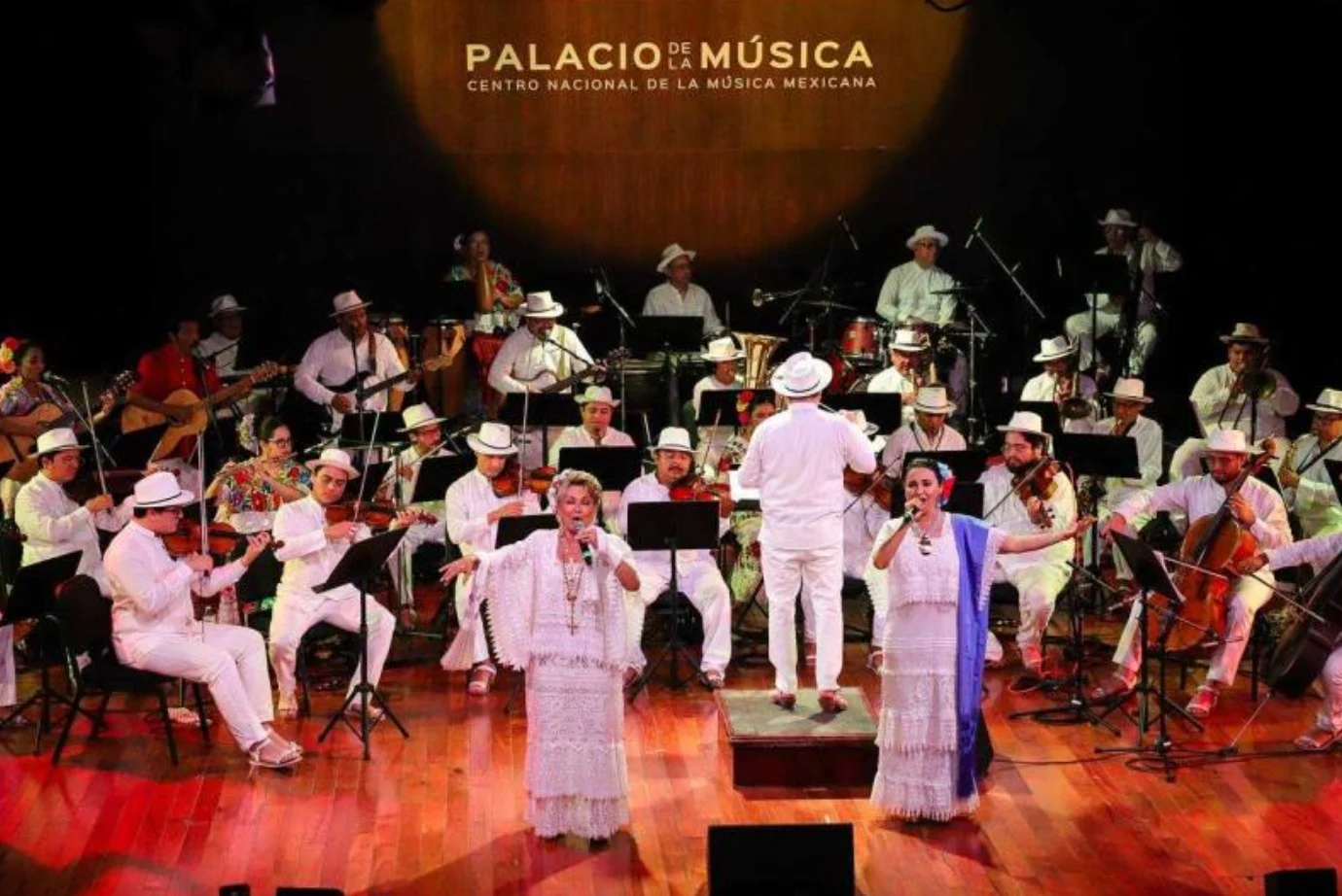 The Orquesta Típica Yukalpetén performing on stage during their 84th anniversary concert at the Palacio de la Música in Mérida, Yucatán.