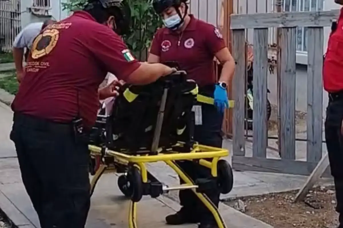 Paramedics providing medical assistance at the scene of a domestic incident in Cancún