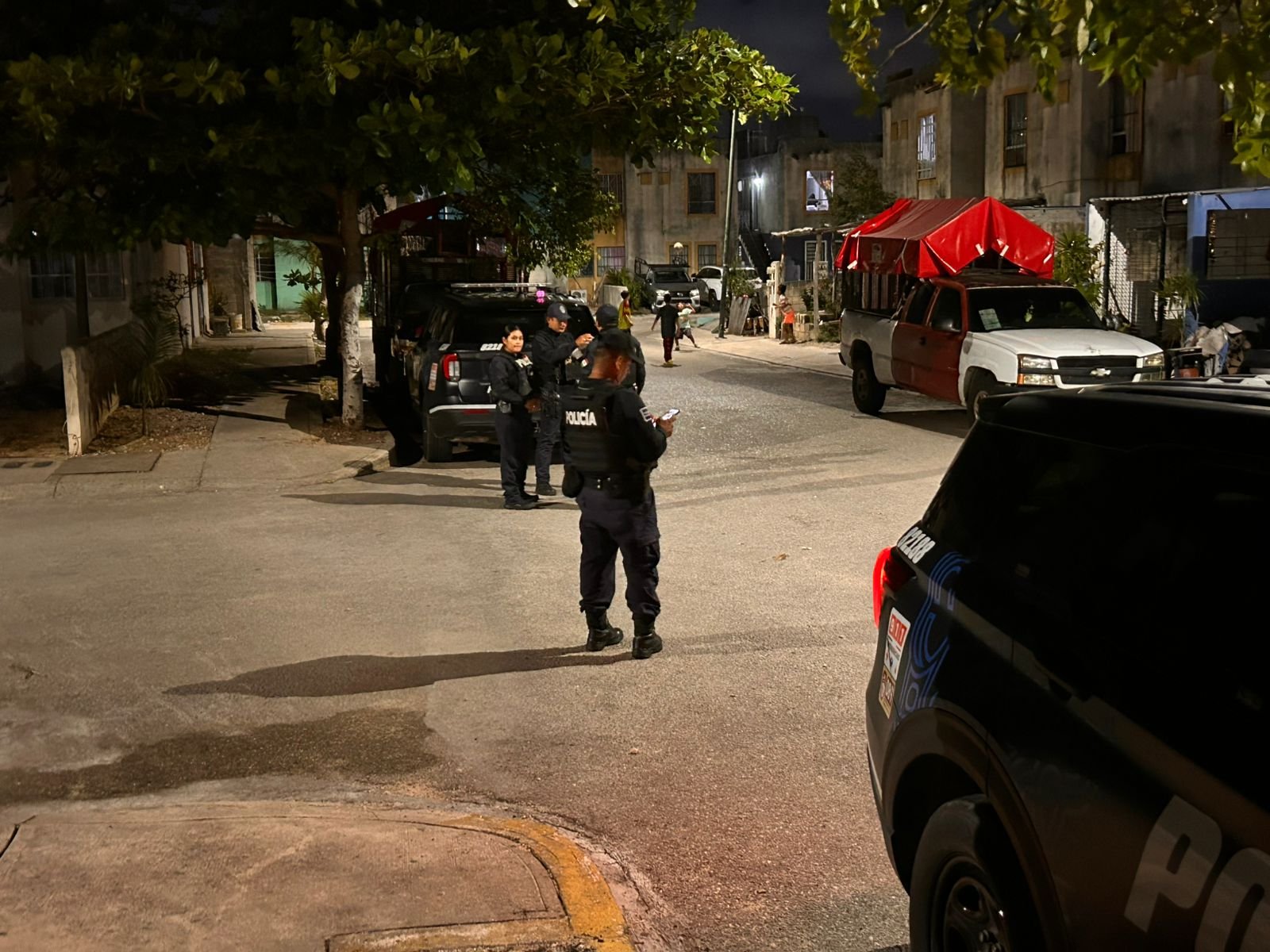 Police and forensic investigators at the scene where a decomposing body was found in Playa del Carmen