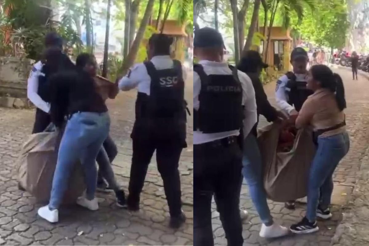 A street vendor in Playa del Carmen interacts with authorities during an enforcement operation
