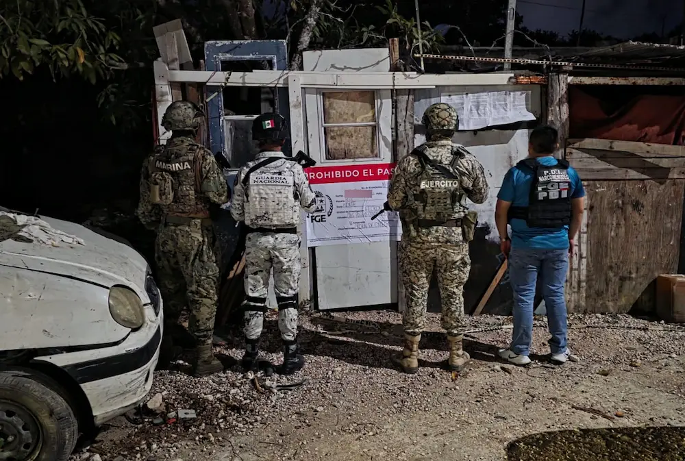 Police officers and military personnel at a drug raid site in Quintana Roo