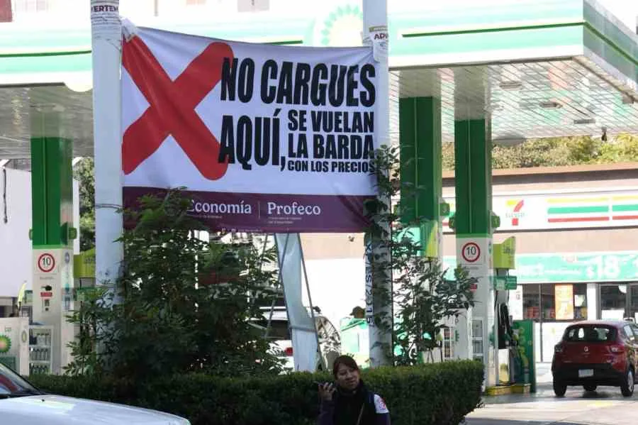 A gas station with price signs showing regular and premium gasoline prices
