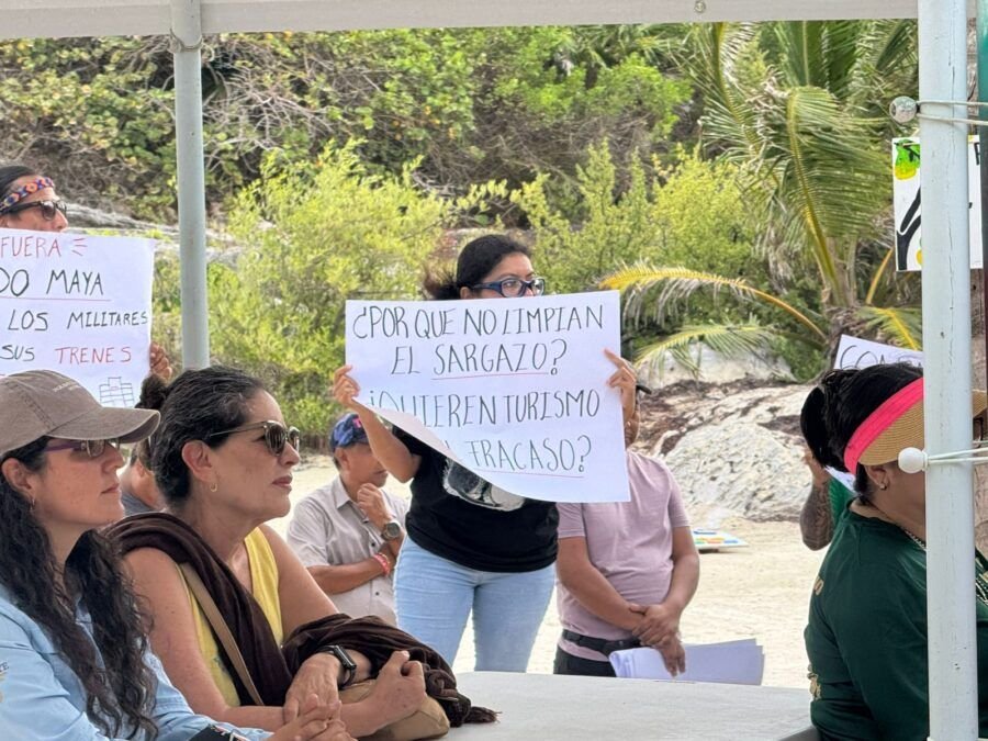 Workers protest at Tulum National Park on its 45th anniversary, holding signs about income loss