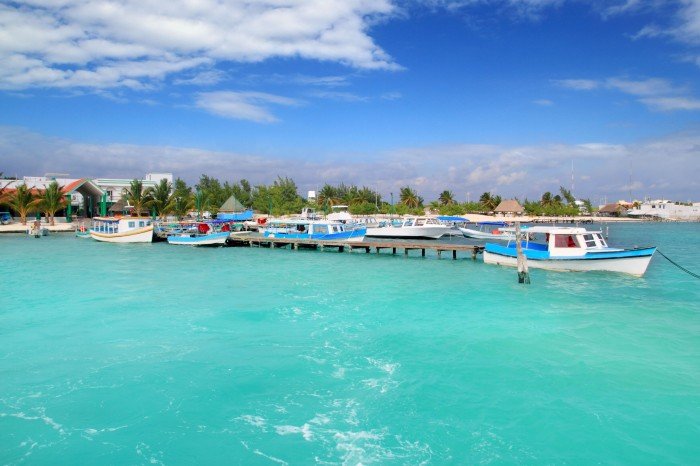 Fishermen working on boats at Puerto Juarez port in Cancun