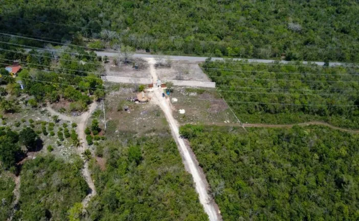 Aerial view showing cleared land and construction equipment in a natural area near Puerto Morelos