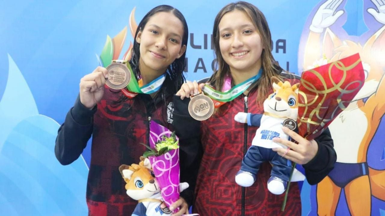 Two female divers from Quintana Roo celebrate with their bronze medals at the CONADE 2026 National Olympiad.