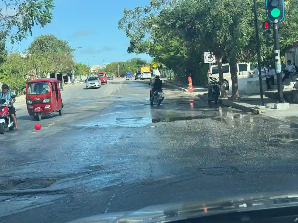 Raw sewage overflowing onto Calzada Puerto Maya street in Puerto Aventuras