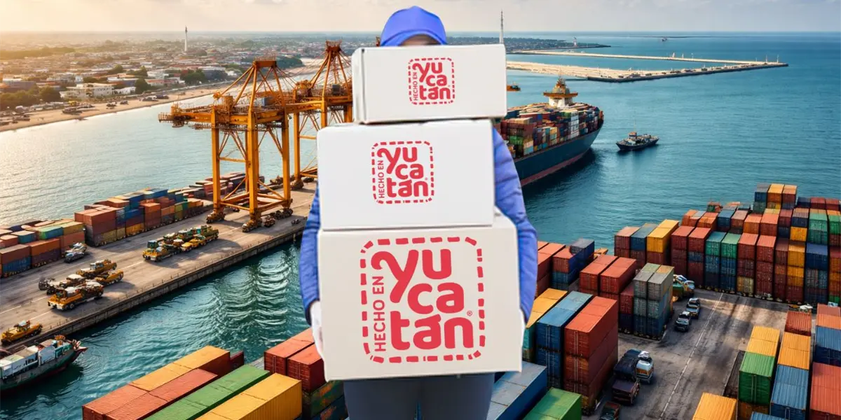 A worker carrying boxes labeled "Hecho en Yucatán" near shipping containers at a port during sunset.$#$ CAPTION