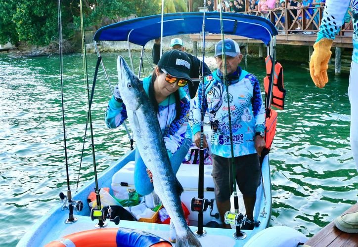 A sport fishing boat on the turquoise waters of the Mexican Caribbean