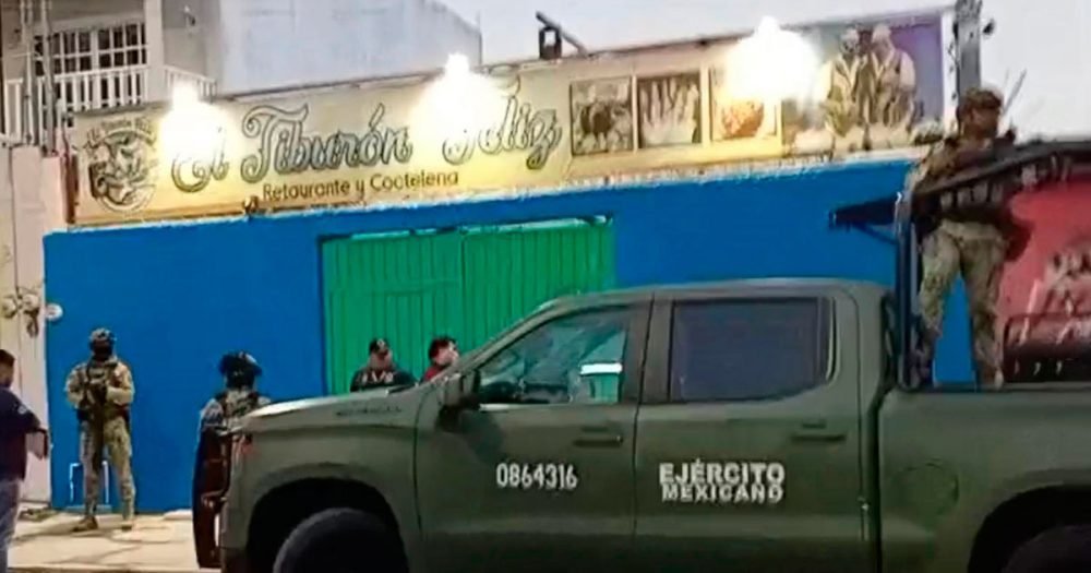 Authorities outside the Tiburón Feliz bar in Cancún during the inspection operation